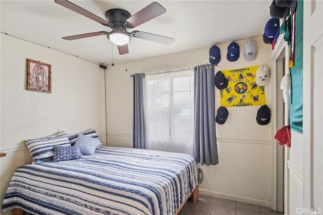 bedroom featuring tile patterned floors, baseboards, and a ceiling fan