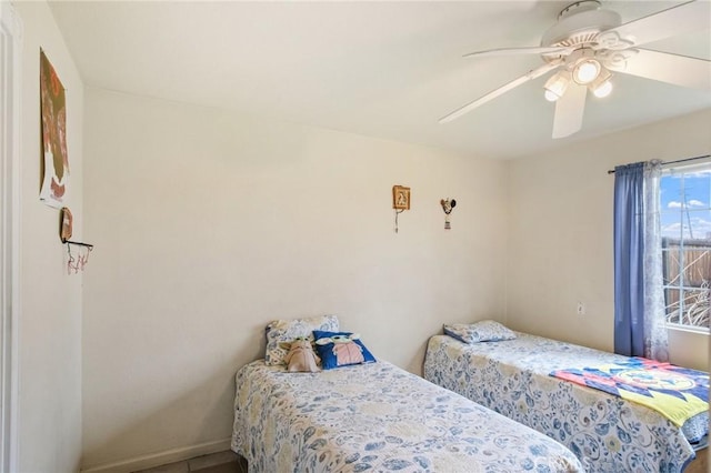 bedroom with baseboards and a ceiling fan