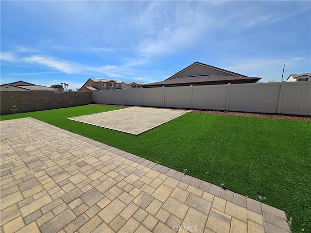 view of yard featuring a patio and a fenced backyard