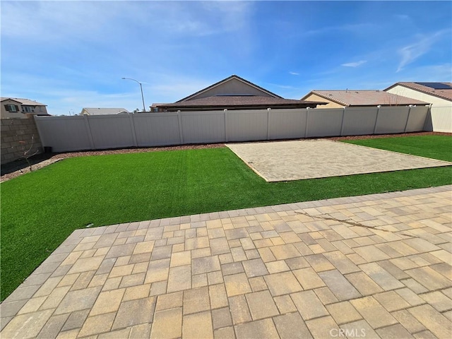 view of yard with a patio area and a fenced backyard