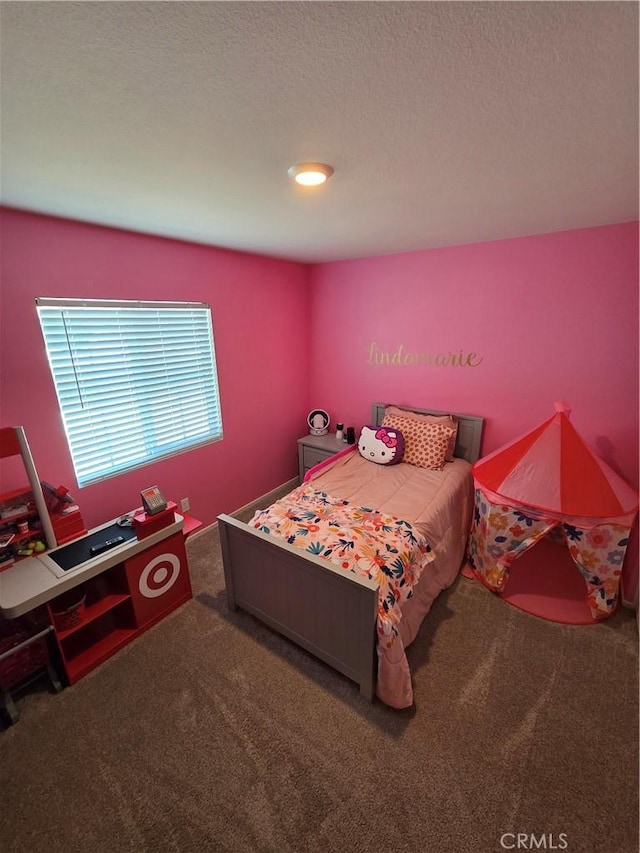 carpeted bedroom with a textured ceiling