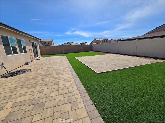 view of yard with a fenced backyard and a patio