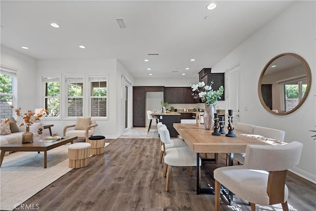 dining room with baseboards, visible vents, recessed lighting, and wood finished floors