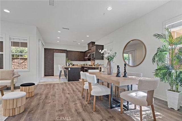 dining space with baseboards, visible vents, recessed lighting, and light wood-type flooring