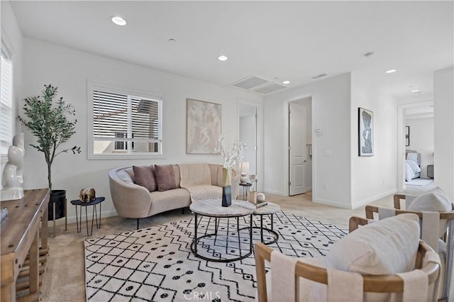 living area featuring light carpet, baseboards, and recessed lighting
