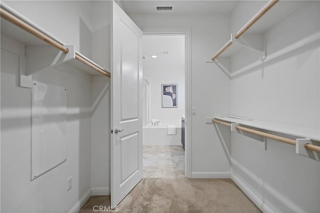 spacious closet with light carpet and visible vents