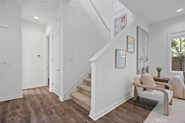 stairs with baseboards, wood finished floors, and recessed lighting