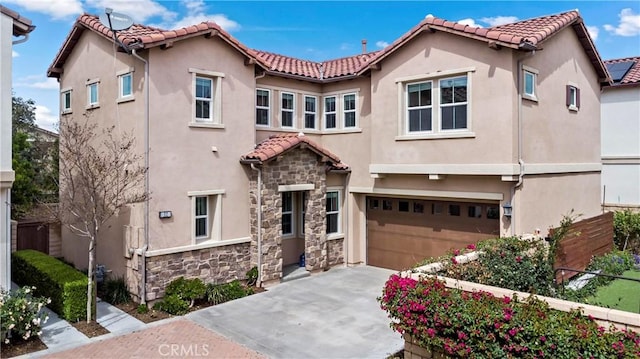 mediterranean / spanish-style house with stone siding, a tile roof, driveway, and stucco siding