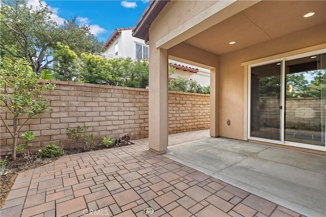 view of patio featuring fence