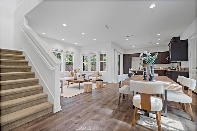 dining area with recessed lighting, visible vents, stairs, and wood finished floors