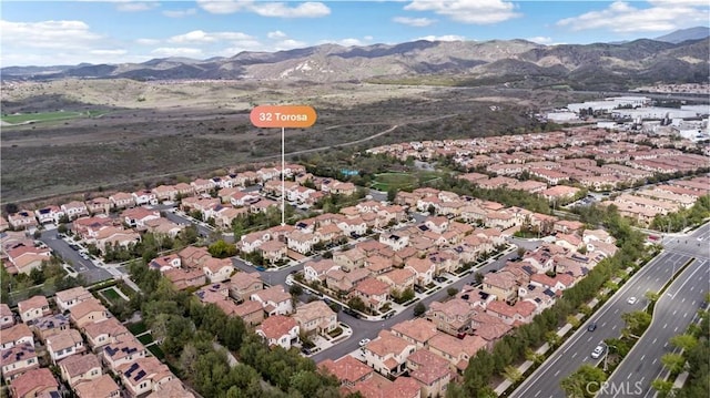 drone / aerial view featuring a residential view and a mountain view