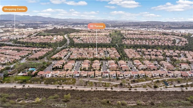 aerial view featuring a mountain view and a residential view