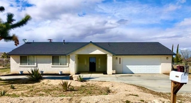 ranch-style home featuring concrete driveway and an attached garage