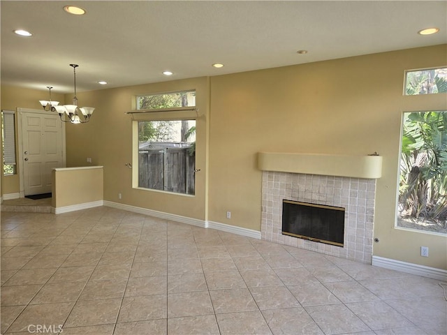 19392 Highridge Way, Trabuco Canyon, CA 92679 - unfurnished living room featuring light tile patterned floors, a tile fireplace, baseboards, a notable chandelier, and recessed lighting
