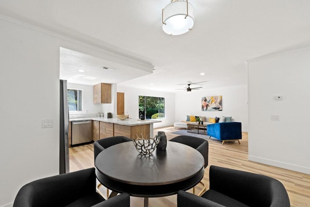 dining space with visible vents, baseboards, light wood-style floors, and ceiling fan