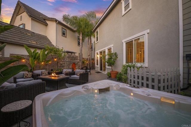2185 Twain Ave, Carlsbad, CA 92008 - pool at dusk featuring an outdoor living space with a fire pit, a hot tub, and a patio area