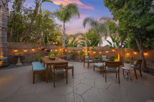 2185 Twain Ave, Carlsbad, CA 92008 - patio terrace at dusk with outdoor dining area, a patio area, and a fenced backyard