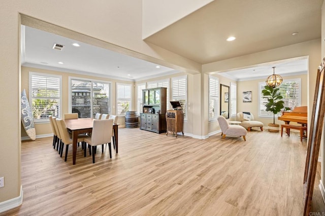 2185 Twain Ave, Carlsbad, CA 92008 - dining room with baseboards, light wood-style floors, ornamental molding, a chandelier, and plenty of natural light