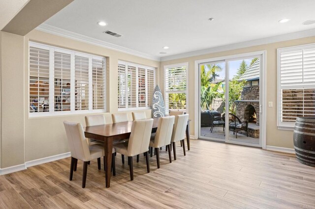 2185 Twain Ave, Carlsbad, CA 92008 - dining area featuring crown molding, baseboards, wood finished floors, recessed lighting, and a brick fireplace