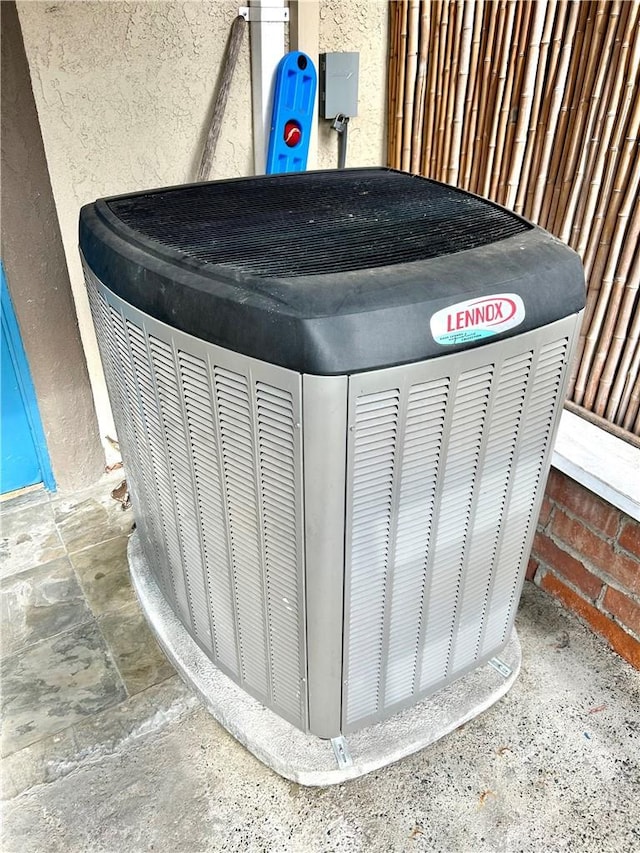 exterior details with central air condition unit and stucco siding