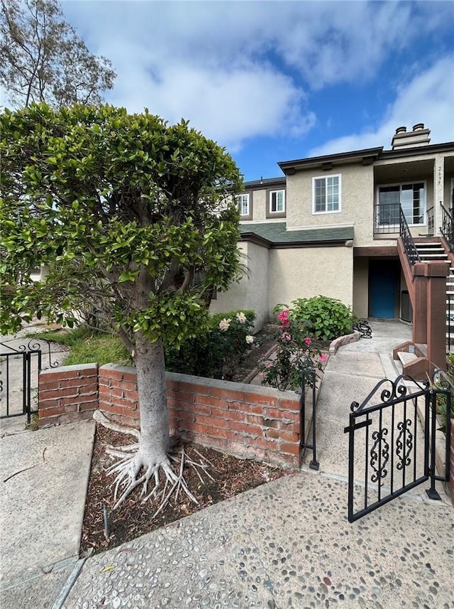 2635 W Monte Carlo Dr Unit 42, Santa Ana, CA 92706 - view of front of home featuring stucco siding, fence, and stairway