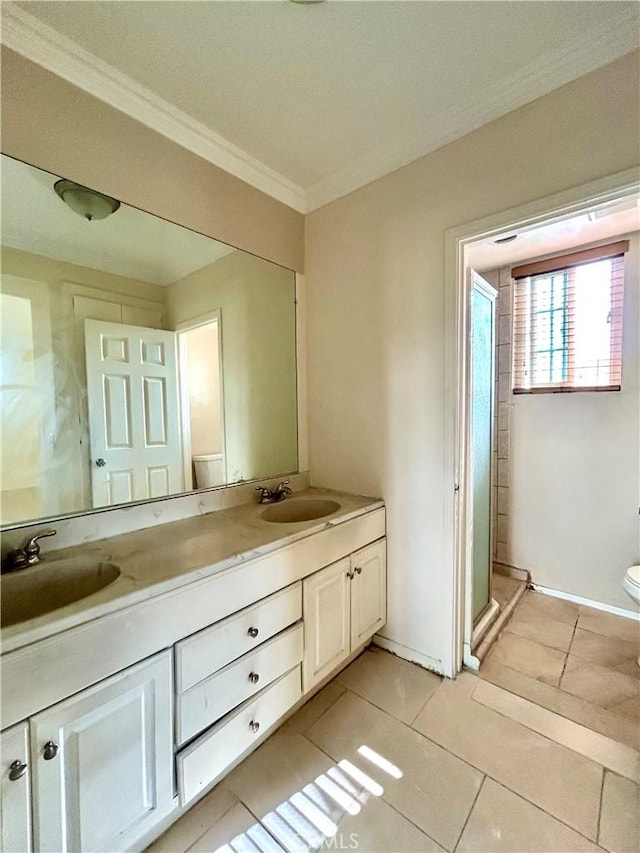 2635 W Monte Carlo Dr Unit 42, Santa Ana, CA 92706 - full bath with tile patterned floors, ornamental molding, double vanity, toilet, and baseboards