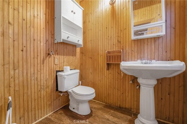 bathroom featuring toilet and wood finished floors