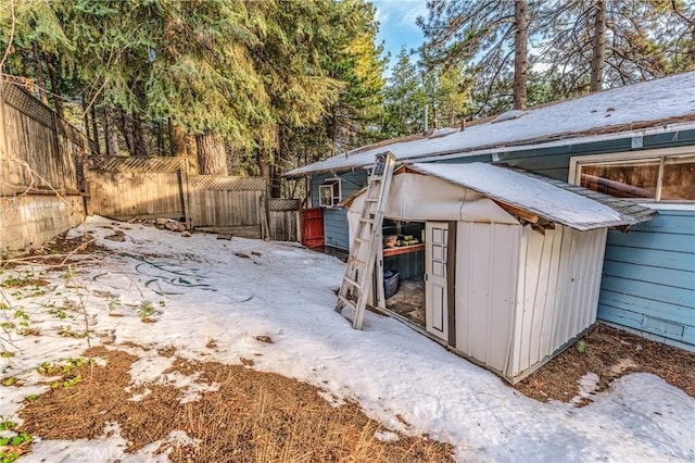 view of side of property with an outdoor structure and fence