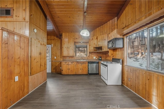 kitchen with white gas range, wood walls, dishwasher, and black microwave