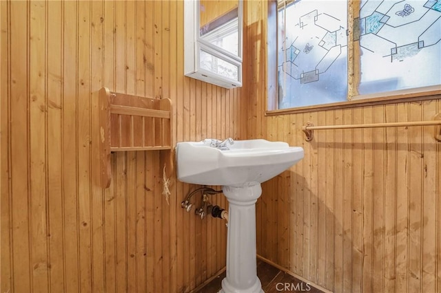 bathroom featuring wood walls
