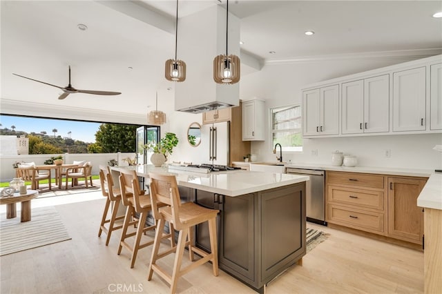 kitchen featuring high quality fridge, a sink, light wood-style flooring, dishwasher, and vaulted ceiling