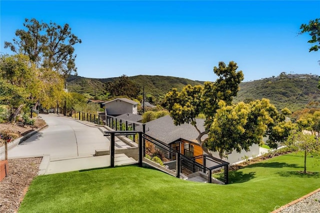 view of home's community with a lawn and a mountain view