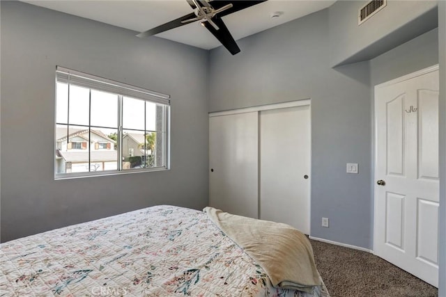 bedroom with ceiling fan, carpet, baseboards, visible vents, and a closet