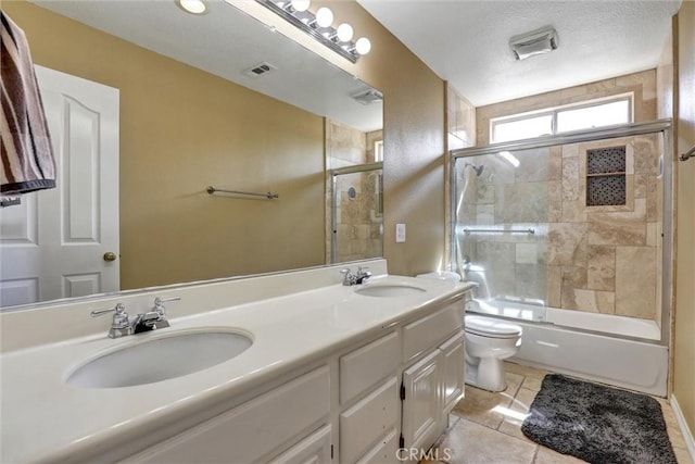 bathroom featuring visible vents, a sink, double vanity, and toilet