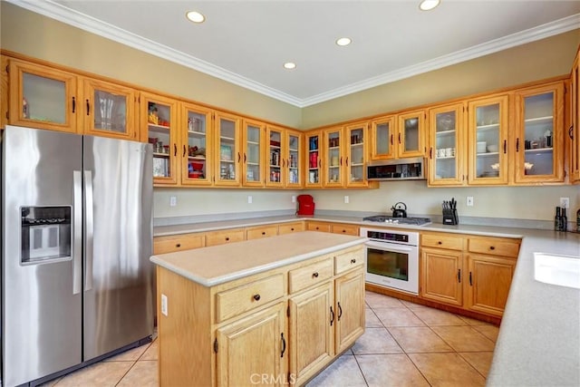 kitchen with light countertops, recessed lighting, appliances with stainless steel finishes, and a kitchen island