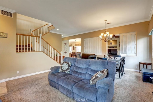 carpeted living area with visible vents, baseboards, a chandelier, ornamental molding, and stairs