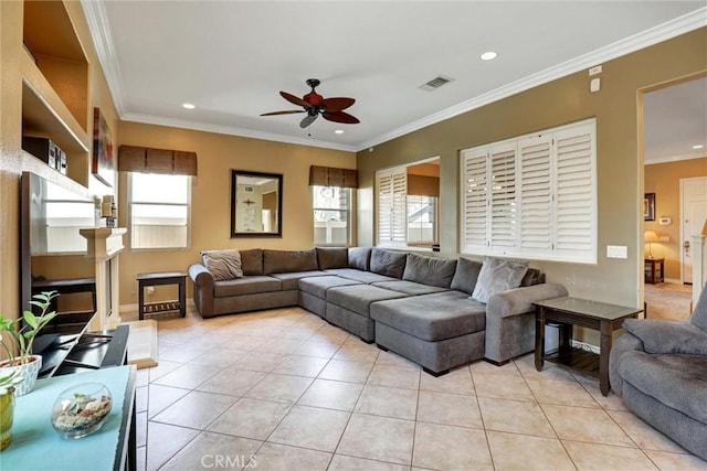 living area with visible vents, ceiling fan, light tile patterned floors, and a healthy amount of sunlight