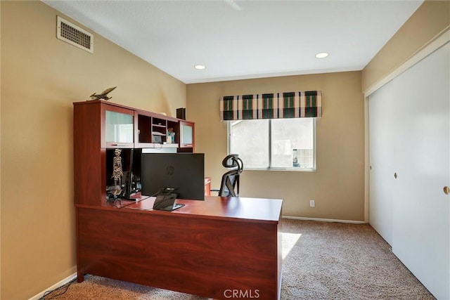 carpeted office space featuring recessed lighting, baseboards, and visible vents