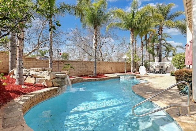 view of swimming pool featuring a patio, a fenced backyard, and a pool with connected hot tub