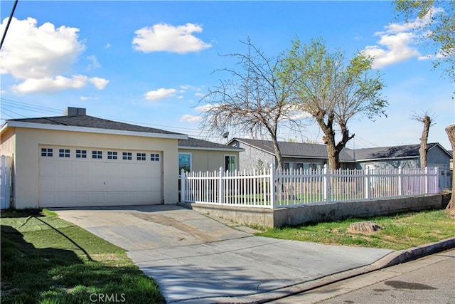 ranch-style house featuring stucco siding, a garage, driveway, and a fenced front yard