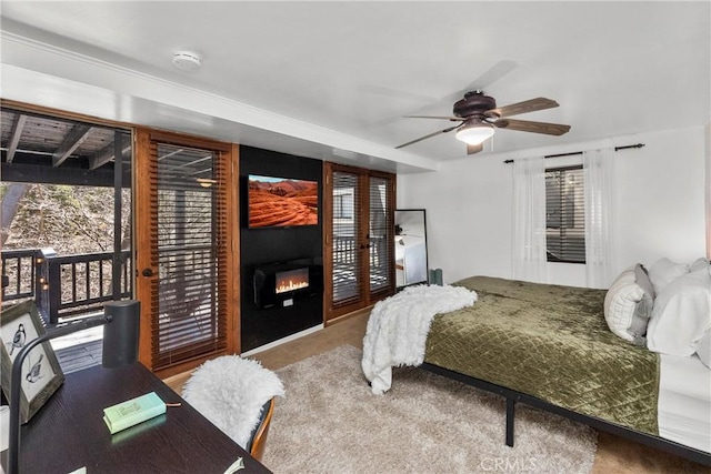28886 Cedar Dr, Lake Arrowhead, CA 92352 - bedroom featuring access to exterior, a large fireplace, carpet, and ceiling fan