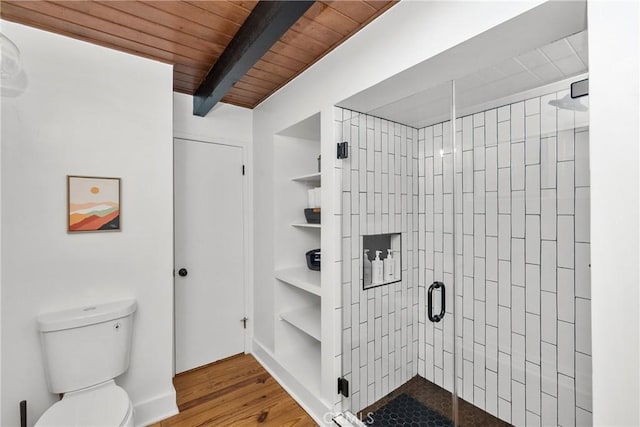 28886 Cedar Dr, Lake Arrowhead, CA 92352 - full bathroom with toilet, a stall shower, wood finished floors, wooden ceiling with exposed beams, and built in features