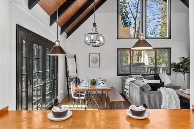 28886 Cedar Dr, Lake Arrowhead, CA 92352 - dining room with a chandelier, wooden ceiling with exposed beams, high vaulted ceiling, and wood finished floors