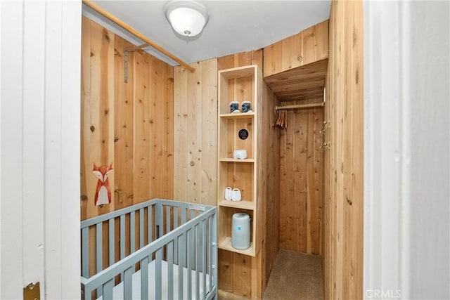 28886 Cedar Dr, Lake Arrowhead, CA 92352 - bedroom featuring wooden walls and a crib