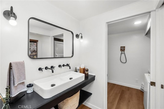 28886 Cedar Dr, Lake Arrowhead, CA 92352 - bathroom with wood finished floors, a sink, crown molding, and baseboards