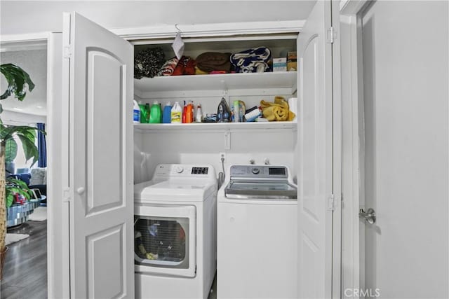 laundry area featuring wood finished floors, washer and clothes dryer, and laundry area