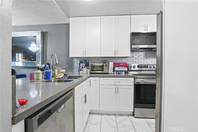 kitchen featuring marble finish floor, a sink, white cabinetry, and stainless steel appliances