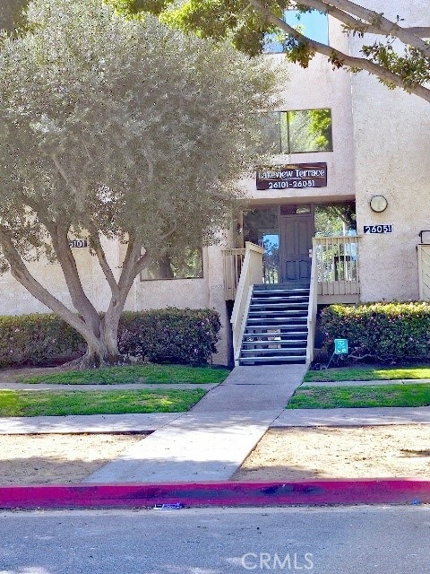 property entrance with stucco siding
