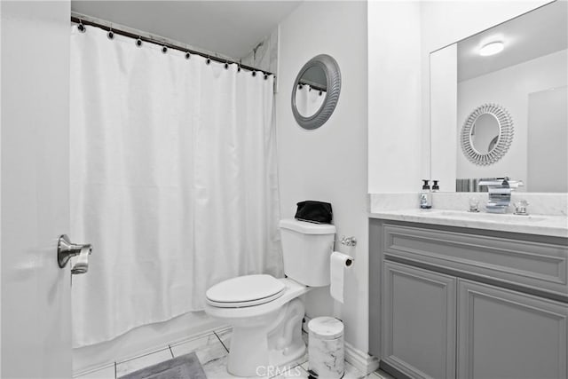 full bathroom featuring toilet, marble finish floor, and vanity