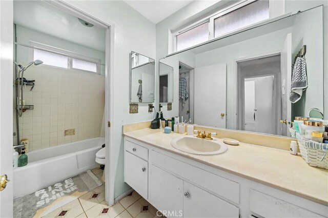 bathroom featuring tile patterned floors, tub / shower combination, toilet, and vanity